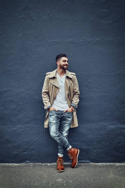 Style that’s hot off the street Shot of a fashionable young man wearing urban wear and posing against a gray wall street style stock pictures, royalty-free photos & images