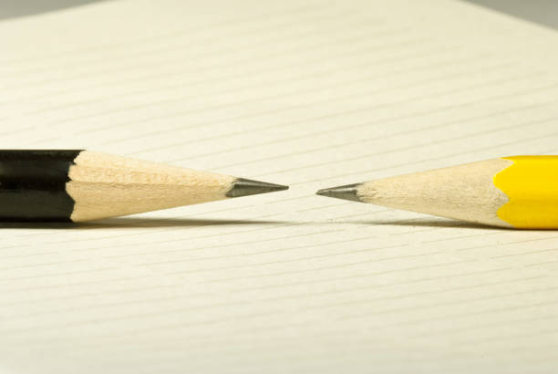 istock Black and yellow pencils  on a white paper 656535240