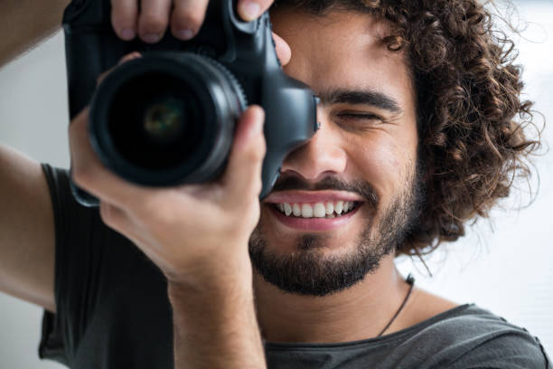 istock Male photographer with digital camera in studio 656538330