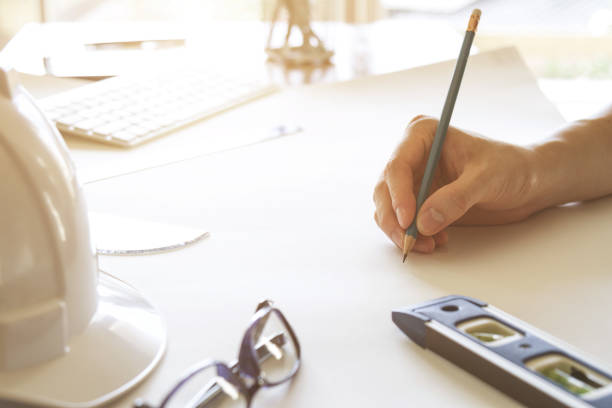 architect working and sketching architectural drawing plan on table in office - instrument of measurement organization housing project housing development imagens e fotografias de stock