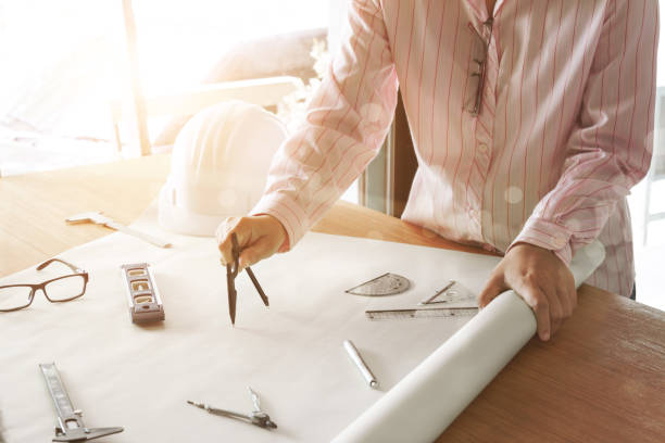 architect working and sketching architectural drawing plan on table in office - instrument of measurement organization housing project housing development imagens e fotografias de stock