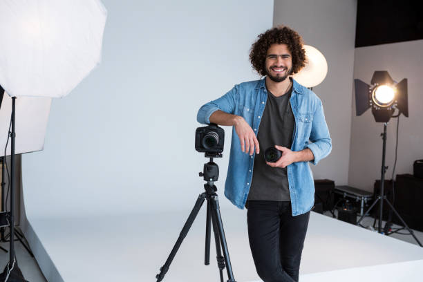 istock Happy male photographer standing in studio 656543572
