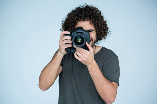 istock Happy male photographer with digital camera in studio 656543632