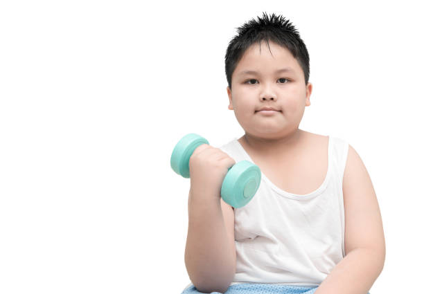 istock obese fat boy is doing exercises with dumbbells 656547442