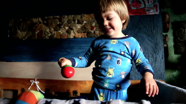 Adorable Blond Kid Playing With Toy Rattle