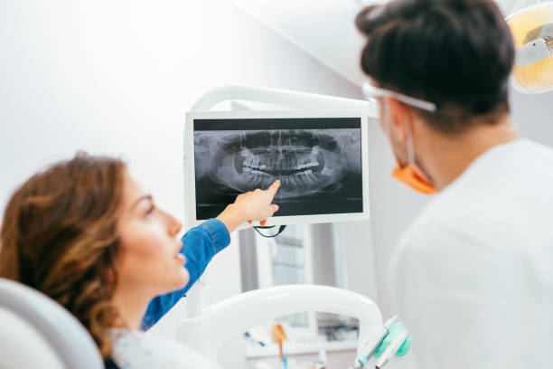 istock Dentist showing a patient her x-ray 656558834