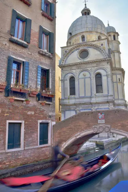 Photo of Santa Maria dei Miracoli with a gondola in Venice, Italy