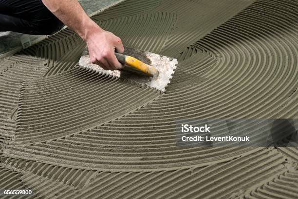 Construction Worker Applying Ceramic Glue Stock Photo - Download Image Now - Cement, Glue, Tile