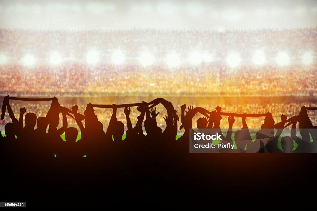 Silhouettes of soccer or rugby supporters in the stadium during match Soccer Stock Photo