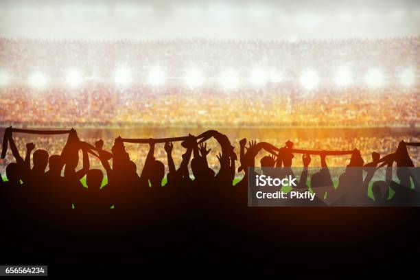 Silhouettes Of Soccer Or Rugby Supporters In The Stadium During Match Stock Photo - Download Image Now