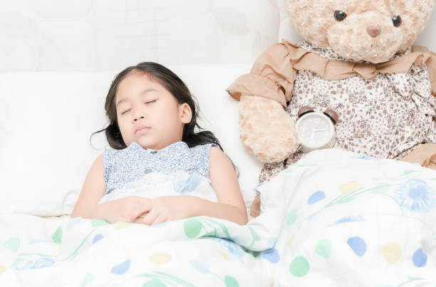 istock Adorable little girl sleeping in the bed 656564652