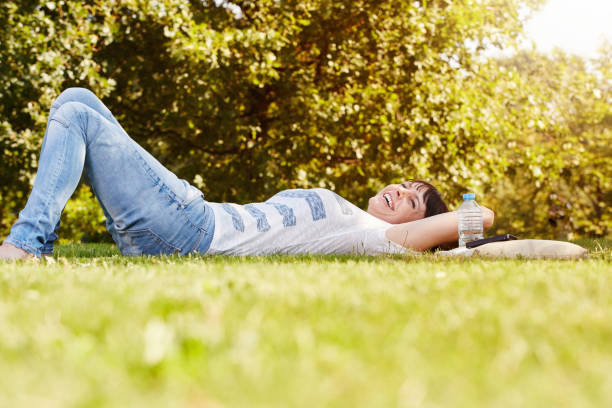 istock comfortable happy woman lying in grass in autumn 656578522