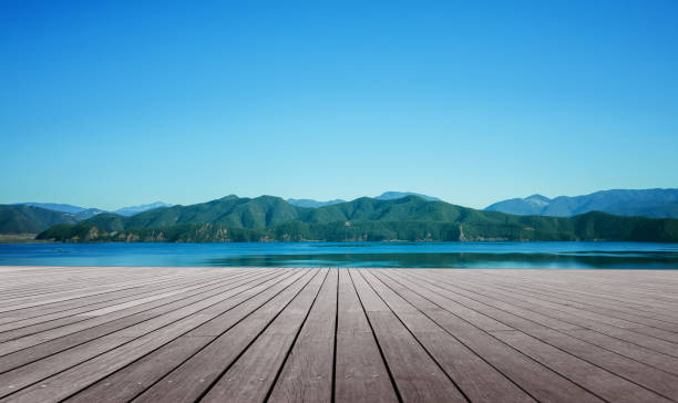 istock wooden floor in front of lake 656579542