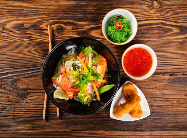 istock Asian prawns with rice noodles and spring rools 656579804