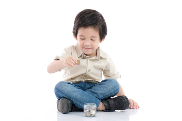 istock Cute Asian child saving money in glass bottle 656580026