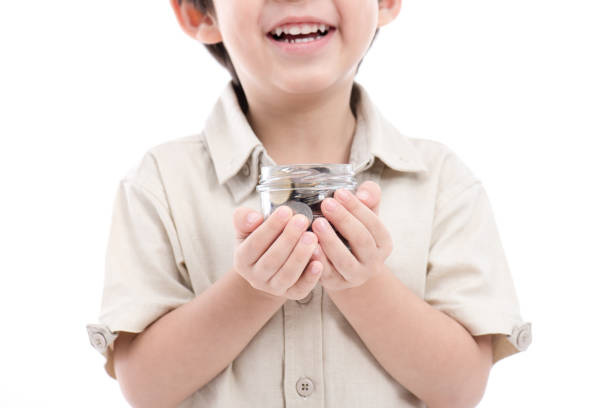 istock Cute Asian child saving money in glass bottle 656580164