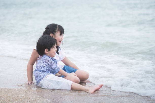 istock asian children playing on the beach 656582462