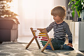 Toddler learning to count on abacus