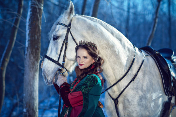 istock girl standing next to a white horse 656587044