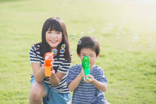 istock Asian chid Shooting Bubbles from Bubble Gun 656588004