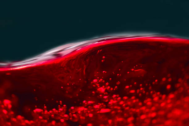 istock Abstract splashes of red wine on a black background 656588222