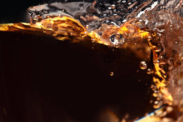 istock splashing of alcoholic drink on a black background 656588568