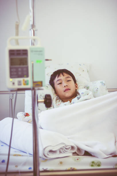 istock Asian boy on sickbed with infusion pump intravenous IV drip. 656588596