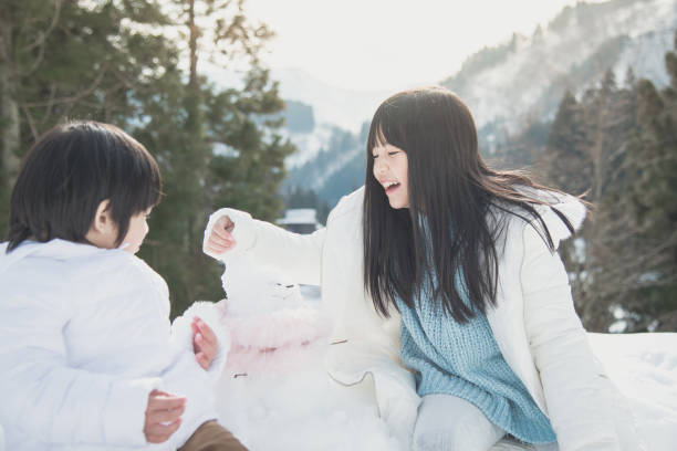 istock Asian children playing with snowman 656591882