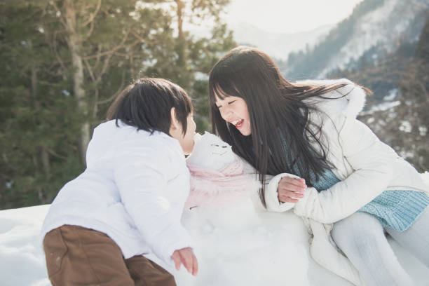 istock Asian children playing with snowman 656591884