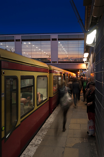 Berlin, Germany - August 27,2014: Commuters arrive with a S-Bahn at the station Ostkreuz during sunset.
