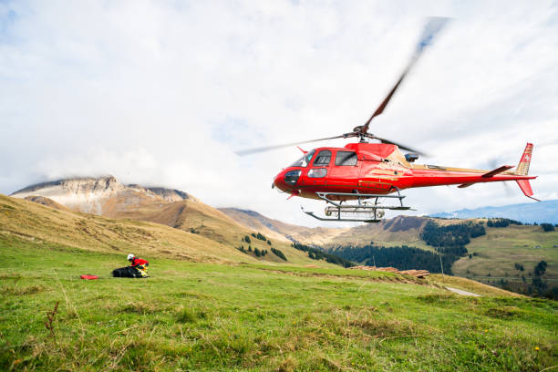 Mountain Rescue Helicopter Takes Off From Mountain Side stock photo