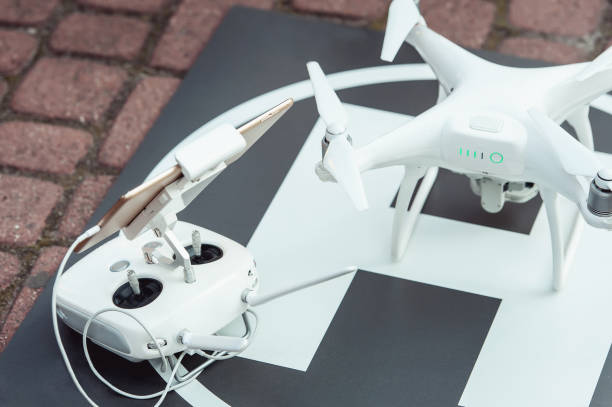 istock remote controller and quad copter on the helicopter landing spot 656595254