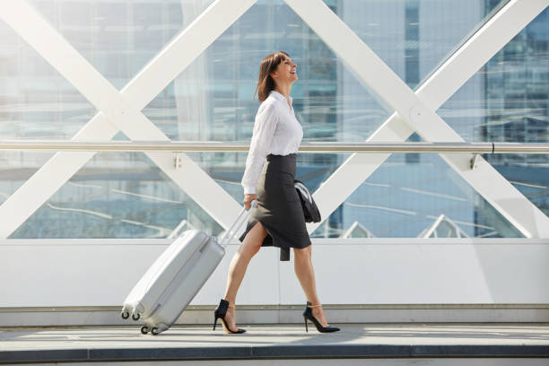 istock business woman walking with suitcase in terminal 656599208