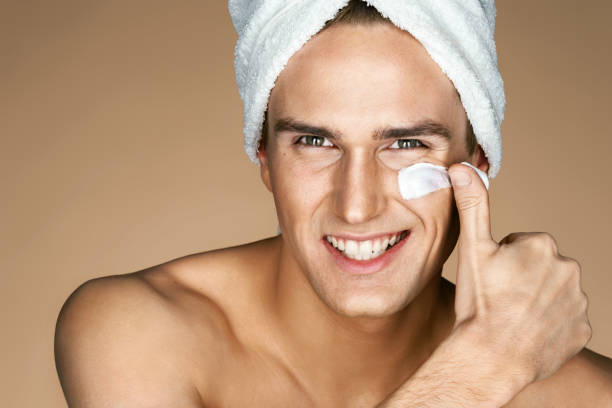 istock Young man applying cream to his face 656599898
