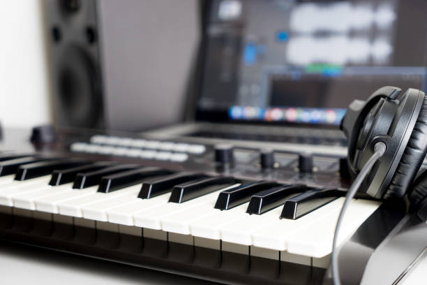 istock Synthesizer keyboard and headphone lying on Music studio working desktop 656602584