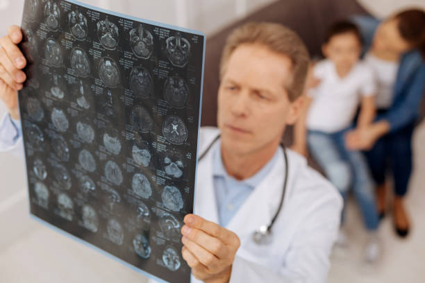 istock Worried focused neurosurgeon examining patients x-ray 656603402