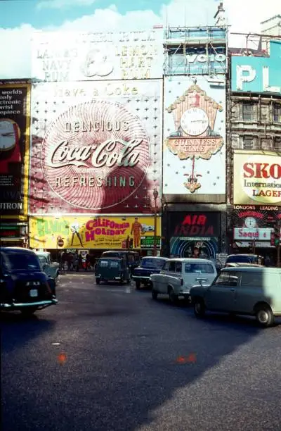 London, England, UK, 1967. Piccadilly Circus. Traffic, passersby, advertising and cinema.