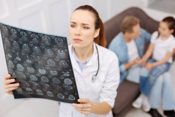istock Concerned neurosurgeon carefully studying MRI brain scans 656606802