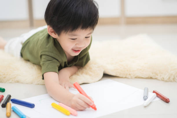 istock child drawing picture with crayon 656607506