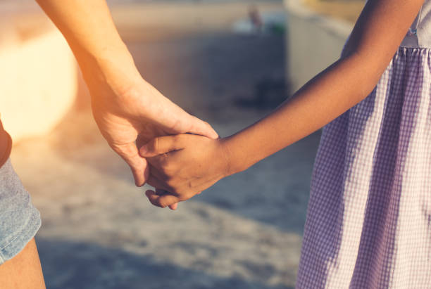 istock Mother with child holding hand on the beach. 656608300