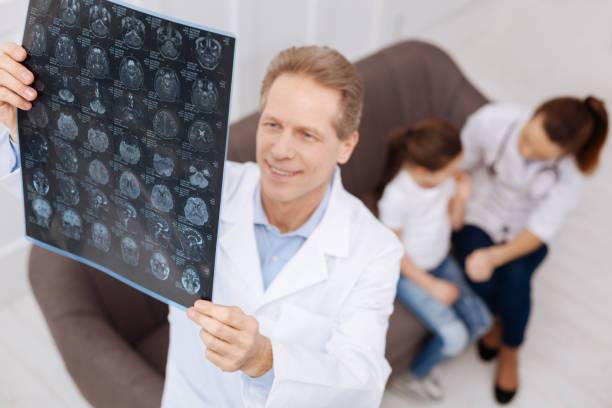 istock Experienced doctors diagnosing little child together 656608498