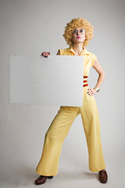 istock Woman WIth Weird 70's Look Holding Blank Sign 656624576