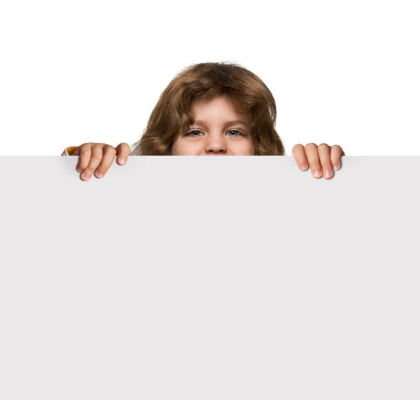 istock Cute little boy behind advertising banner 656630352