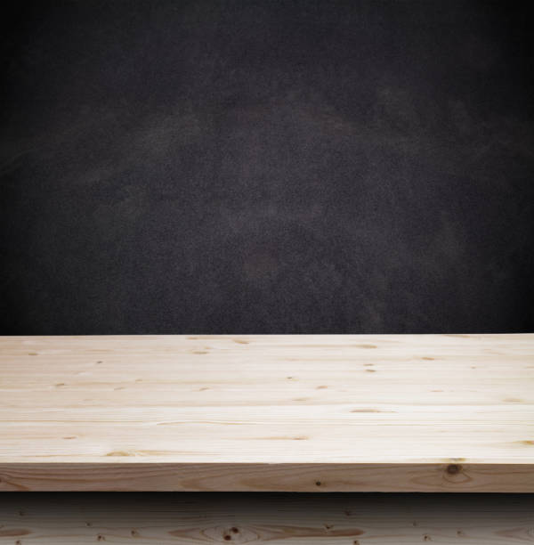 istock Empty wooden table for product display over grunge black wall 656635198