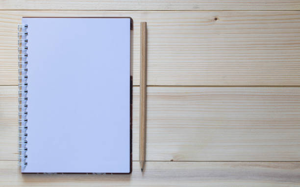 istock A Notebook with a pencil and smart on the wooden background. 656639586