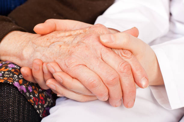 istock Young doctor holds the elderly woman hands 656641724