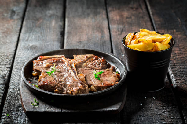 istock Tasty tbone steak and chips with salt and pepper 656641940