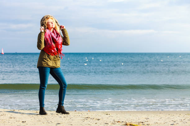 istock Woman relaxing on beach, cold day 656644988