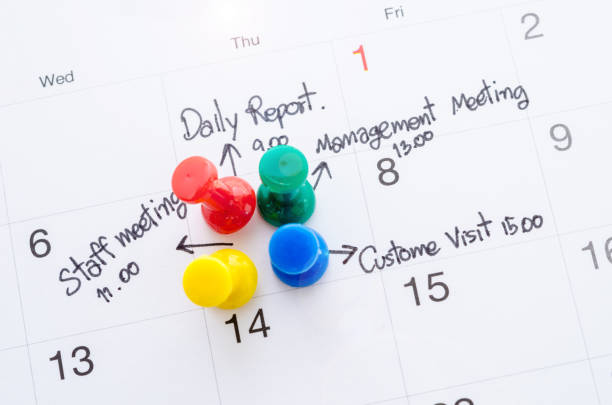 Pushpin on calendar with busy day overworked schedule.