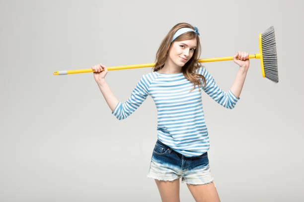 istock Young woman with broom 656645480